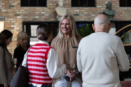 Woman greeting guests at NeoCon showroom